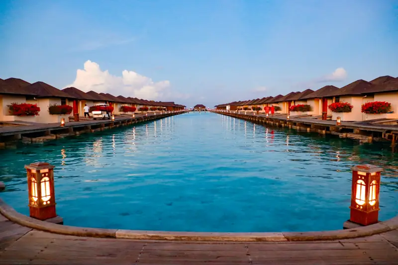 Overwater bungalows lining a tranquil turquoise lagoon